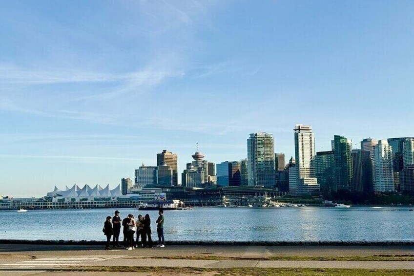 A city skyline with modern buildings and a waterfront. 5