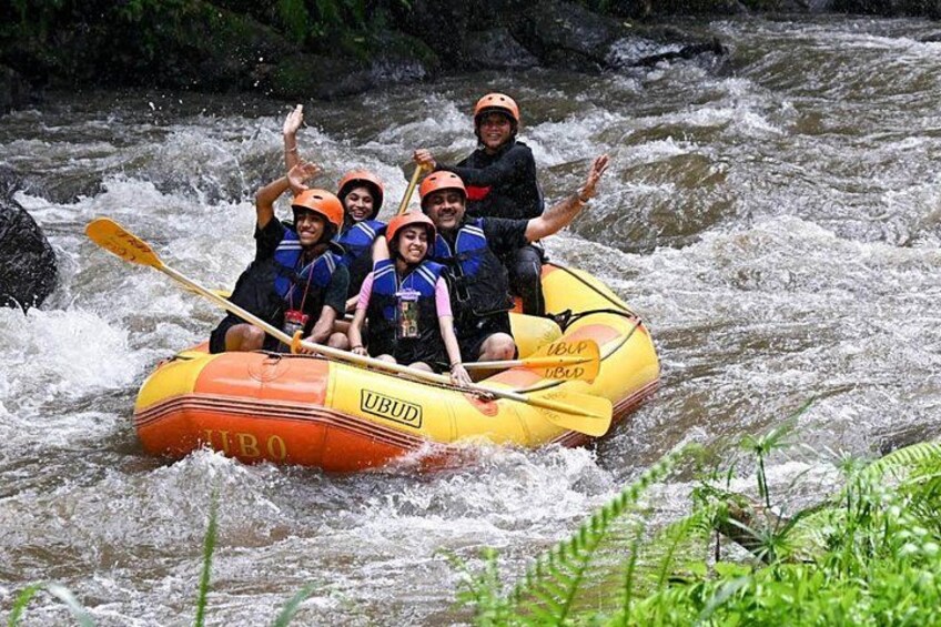 A group of people in a yellow inflatable raft on a river. 4