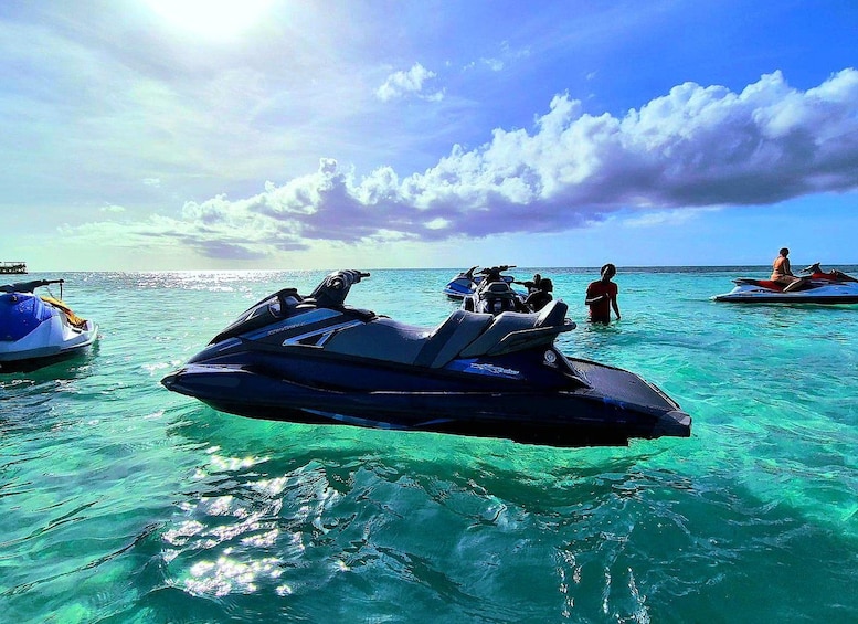 A jet ski in the water with people around it. 1