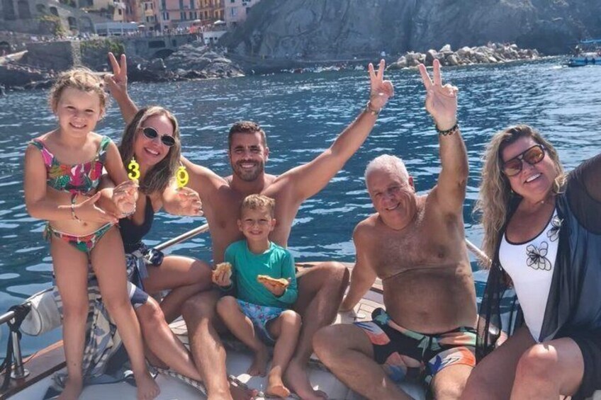 Un grupo de personas en un bote con acantilados rocosos al fondo. 5