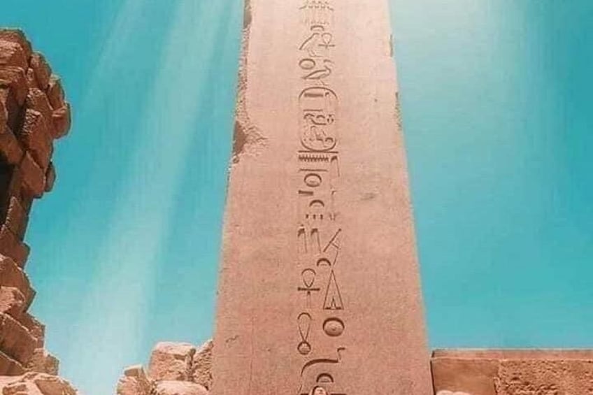 A tall, narrow stone pillar with hieroglyphs carved into it. 3