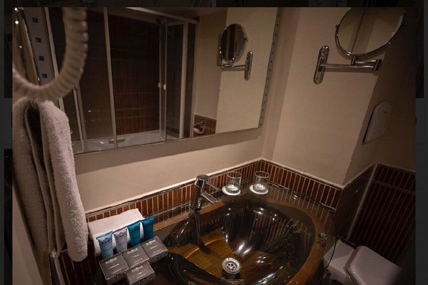 A bathroom with a bathtub, a mirror, and a towel rack. 4