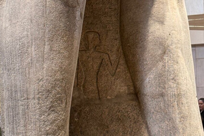 A large stone pillar with a carved figure. 3