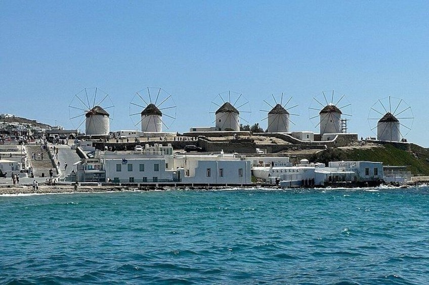 Windmills, white buildings, and a coastline. 3