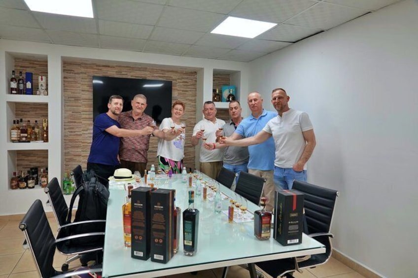 A group of people in a meeting room with a table displaying various bottles and boxes. 3