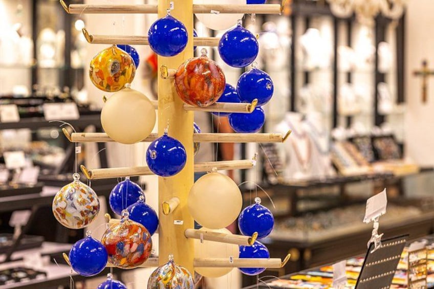 A display of colorful glass ornaments on a wooden rack. 4