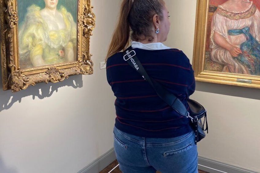 A person viewing paintings in an art gallery. 5