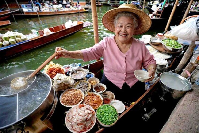 A person cooking on a boat with various ingredients and cooking utensils. 1