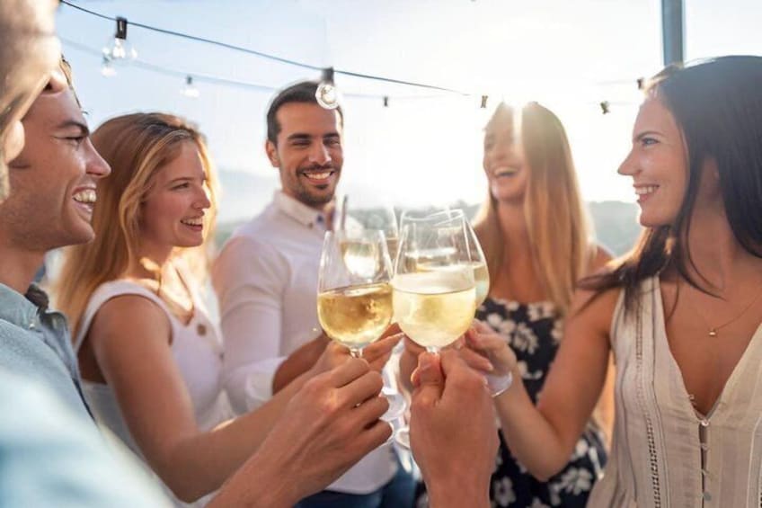 A group of people toasting with wine glasses. 2