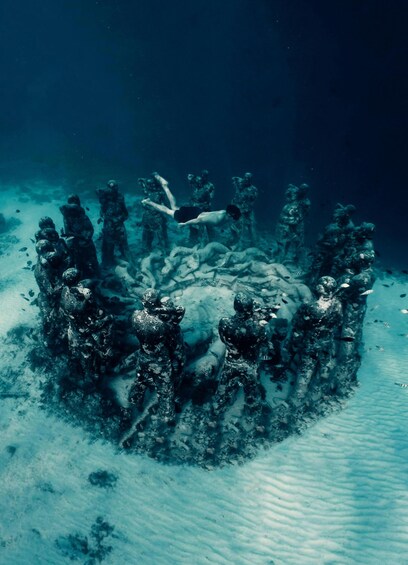 An underwater scene with divers around a central structure, surrounded by marine life. 3