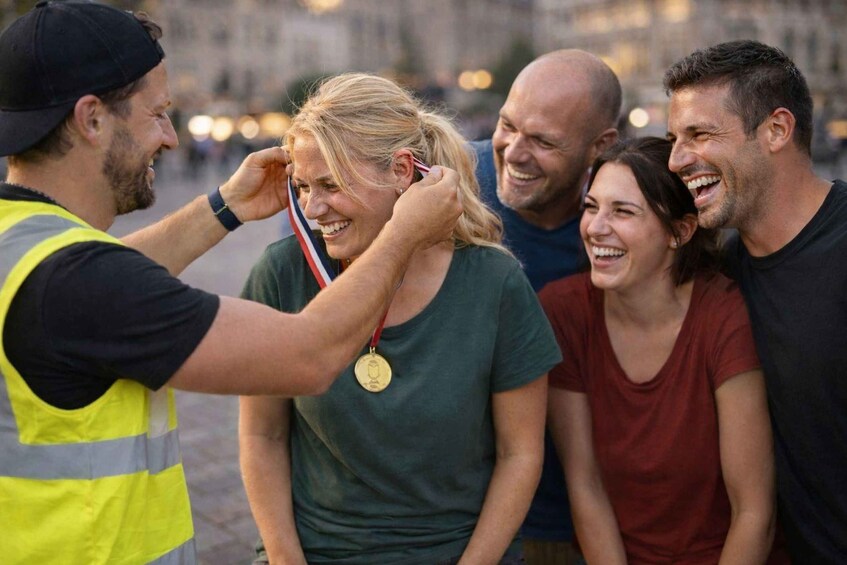 A person receiving a medal from another individual. 4