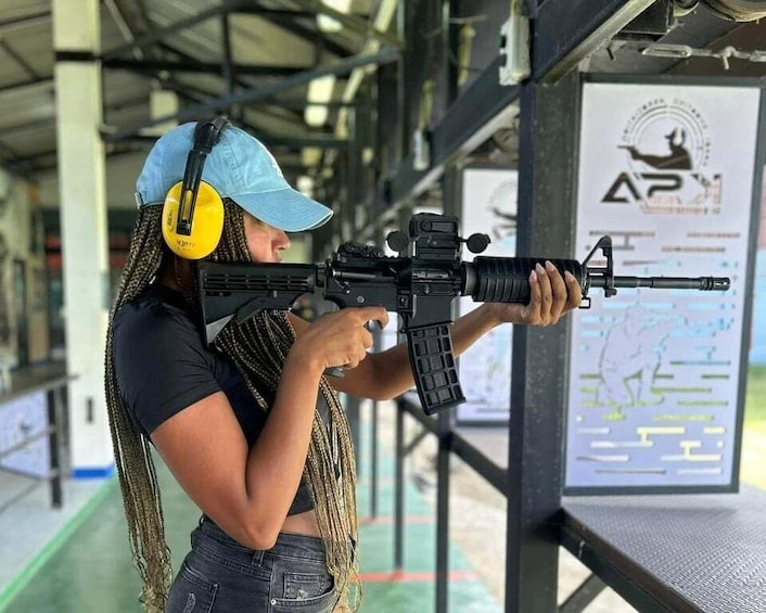 A person aiming a rifle at a shooting range. 5