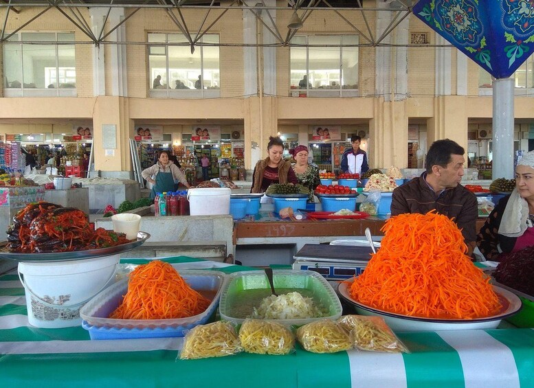 A market stall with various vegetables and a building in the background. 4