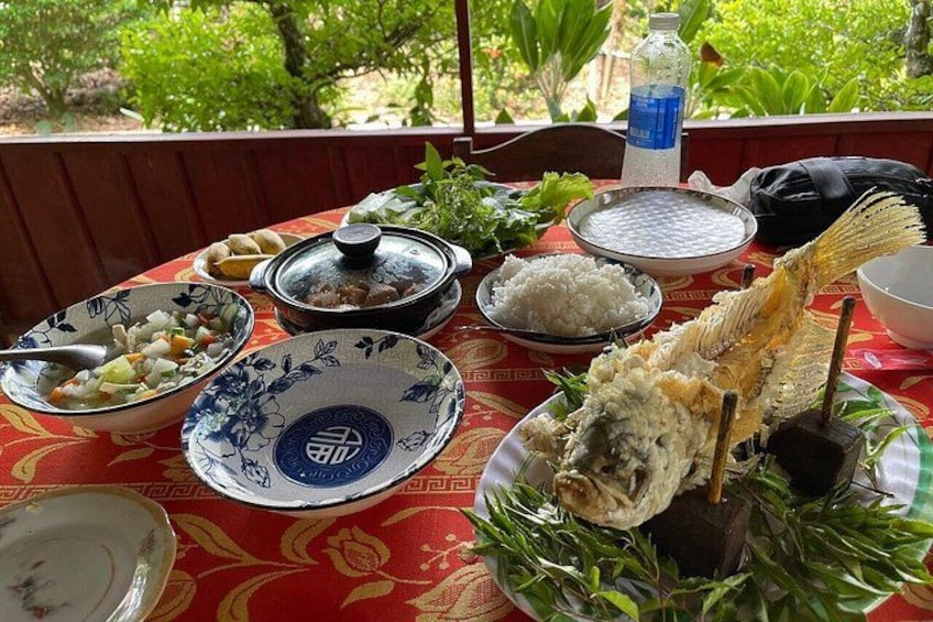 A table with various dishes, including rice, fish, and a bowl of soup. 5