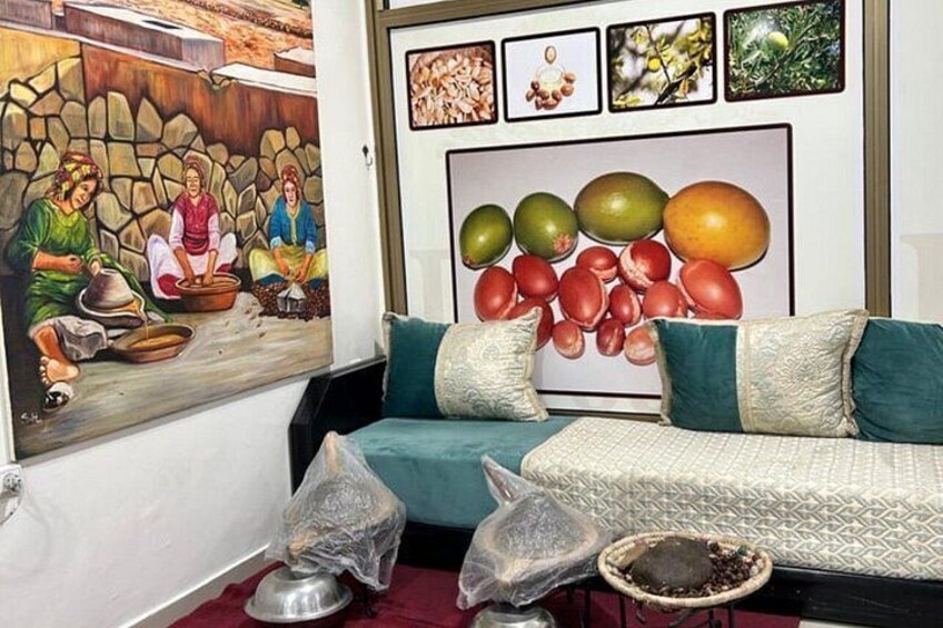 A living room with a sofa, a painting, and a fruit-themed wall decoration. 5