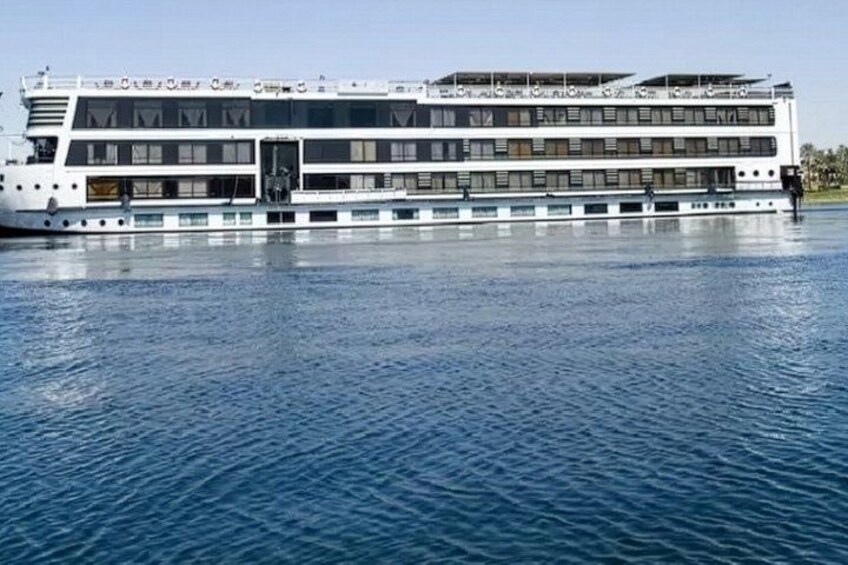 A large, multi-deck river cruise ship on calm water. 1