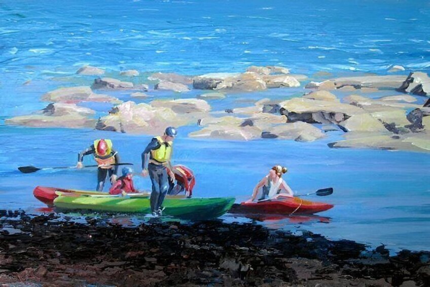 People in kayaks on a rocky shore with calm water. 3