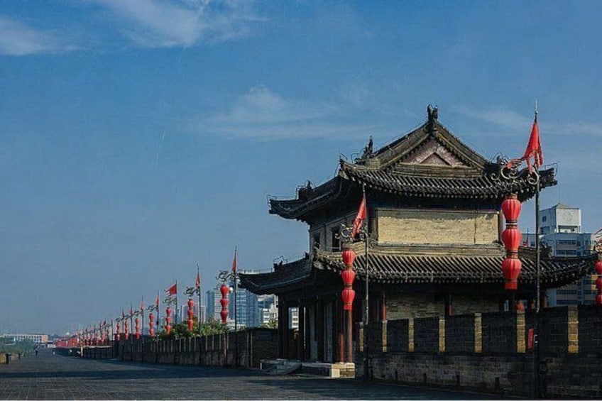 A traditional Chinese building with red lanterns and flags. 2