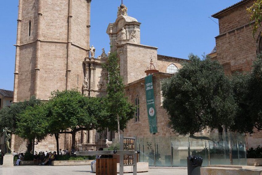 A historic church with a tall bell tower and a green banner. 4