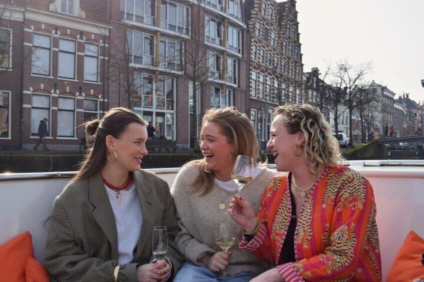 Three people sitting on a rooftop with a cityscape in the background. 4