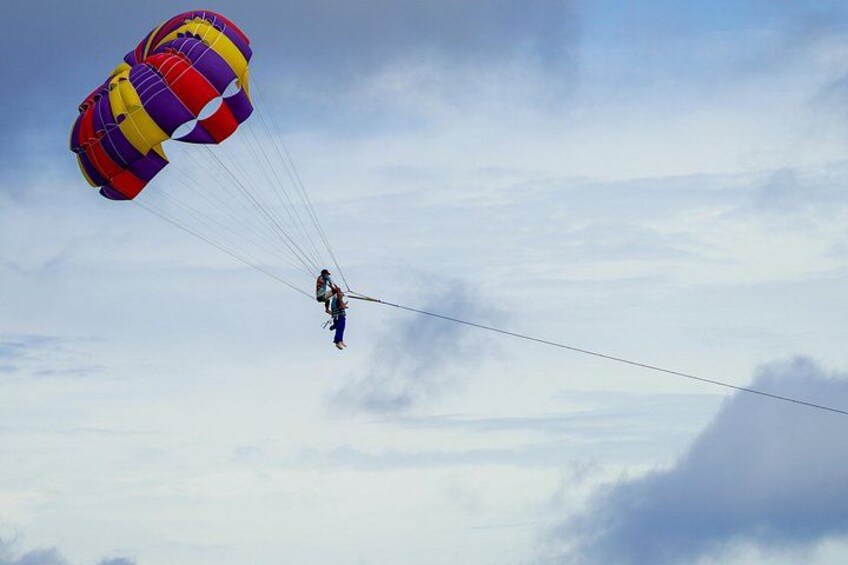 A person skydiving with a parachute. 3