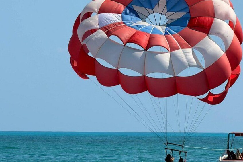 A parachute with red and white stripes over a body of water. 5