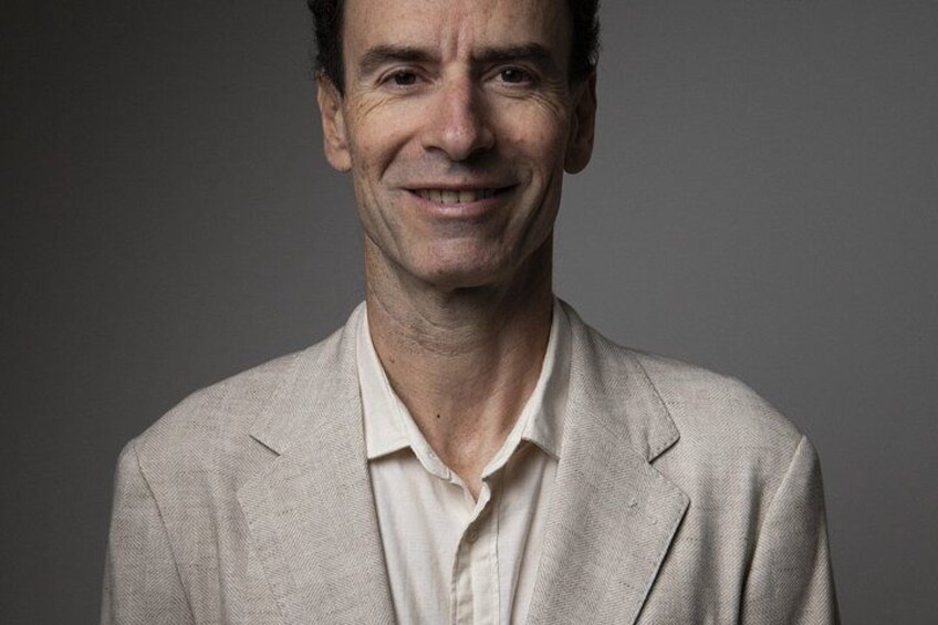 A person wearing a light-colored suit jacket and a white shirt. 2