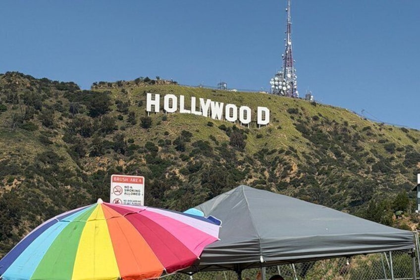 The Hollywood sign on a hill, a tent, and a 'No Parking' sign. 5