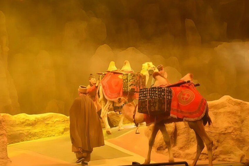 A desert scene with camels and riders. 2