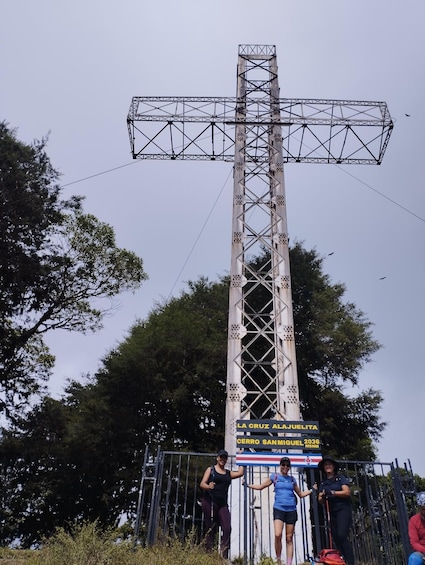 A large metal cross structure with a sign at its base. 4