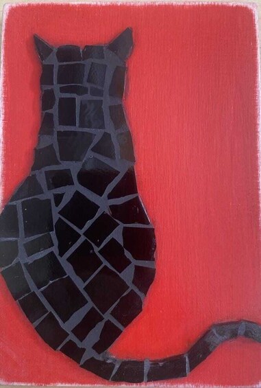 A mosaic of a cat silhouette on a red background. 2