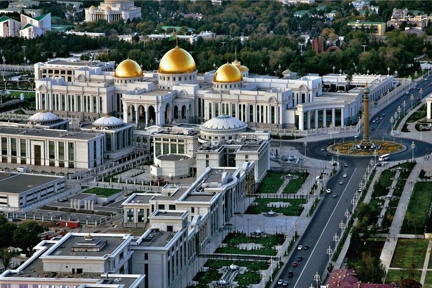 A cityscape with a prominent building featuring golden domes, a central roundabout, and a well-maintained urban environment. 5