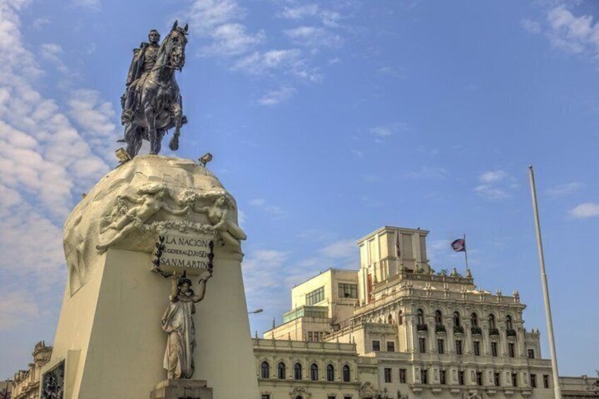 A statue of a man on horseback with a building in the background. 2
