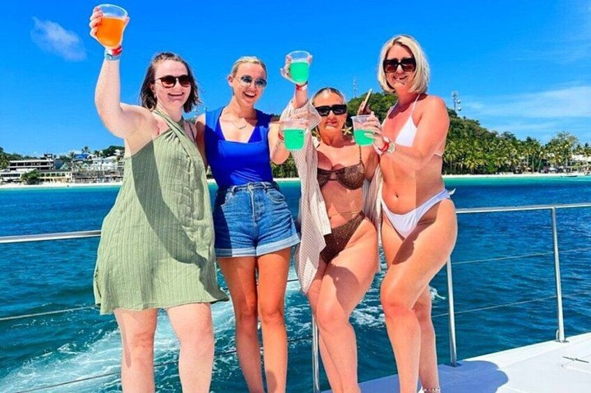 A group of people on a boat with a clear blue sky and a calm sea. 5
