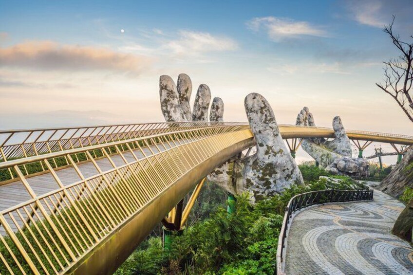 A bridge with a unique design, large rock formations, and a clear sky. 5