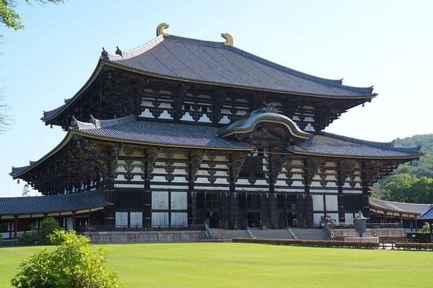 A traditional Japanese building with a curved roof and ornate wooden details. 1