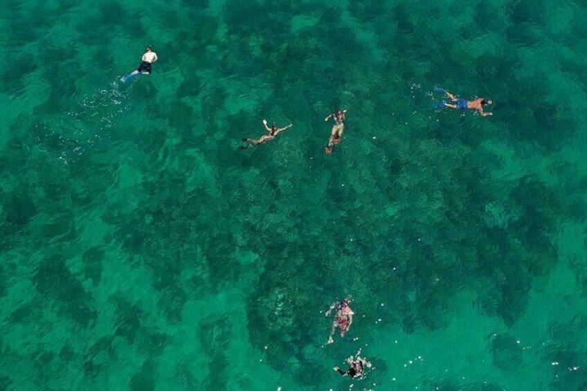 People swimming in clear turquoise water. 5
