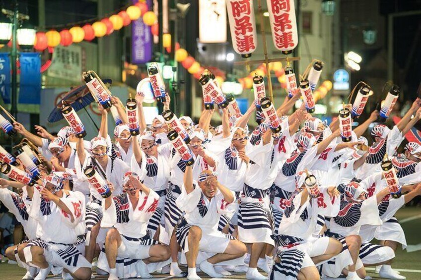A group of people in white and blue uniforms holding bottles, possibly celebrating. 1