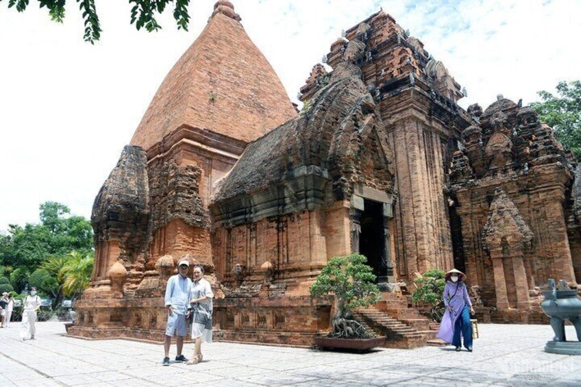 An ancient temple with a large central tower and intricate carvings. 5