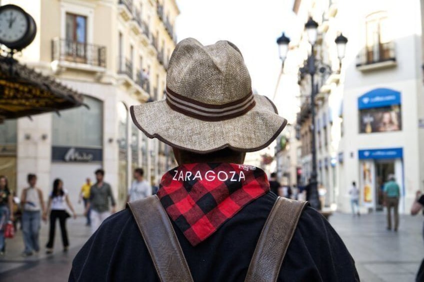 A person wearing a hat and scarf with the text 'ZARAGOZA' on the scarf. 3