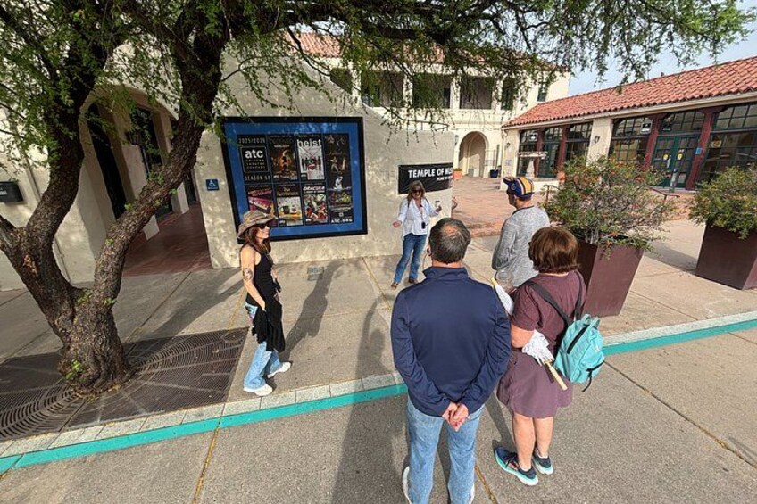 People standing in front of a building with a sign that reads 'Temple of'. 2