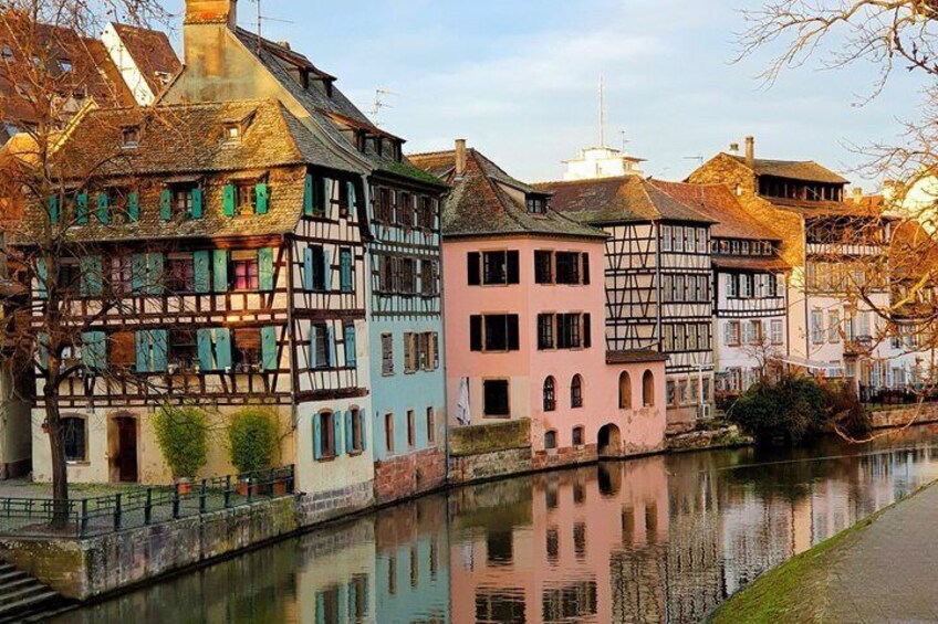 A canal with traditional half-timbered houses reflecting on the water. 2