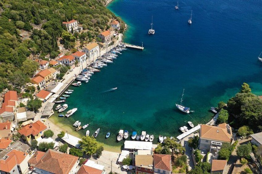 A coastal town with a marina, boats, and houses with red roofs. 3