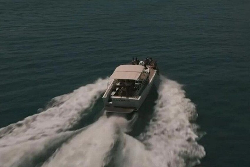 A boat moving through the water, creating a wake behind it. 2
