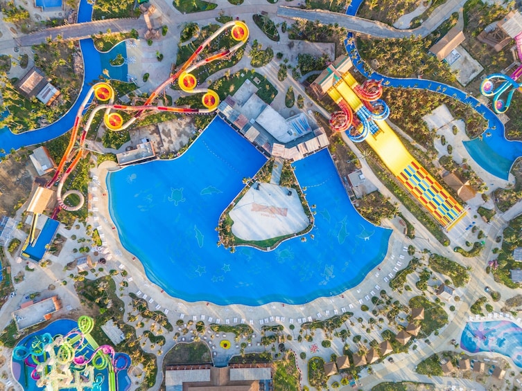 An aerial view of a water park with multiple slides and pools. 1