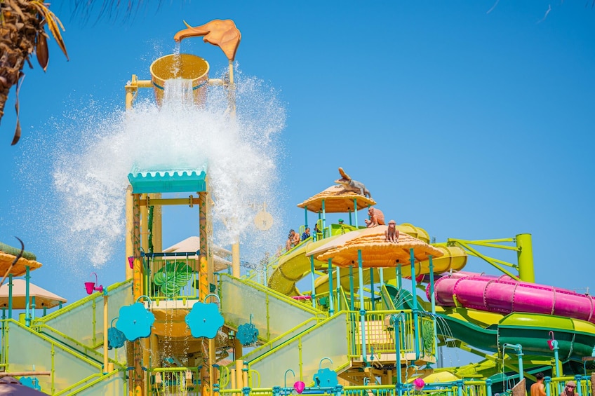 A water park with a water slide, a wave machine, and a splash tower. 2