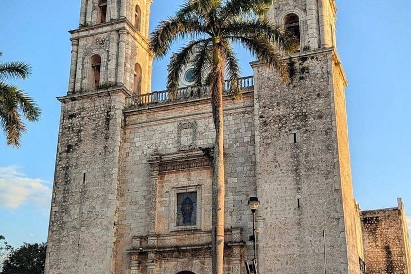 A historic stone church with two bell towers and a central entrance. 2