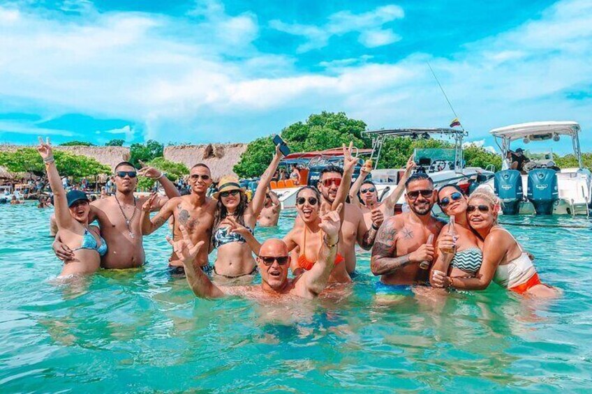 A group of people in a swimming pool with boats in the background. 4