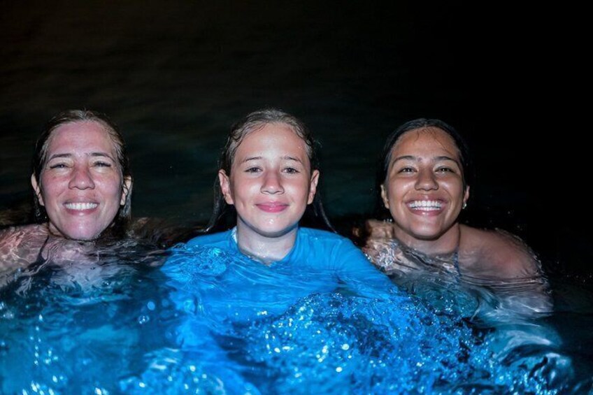 Three people in a swimming pool. 3