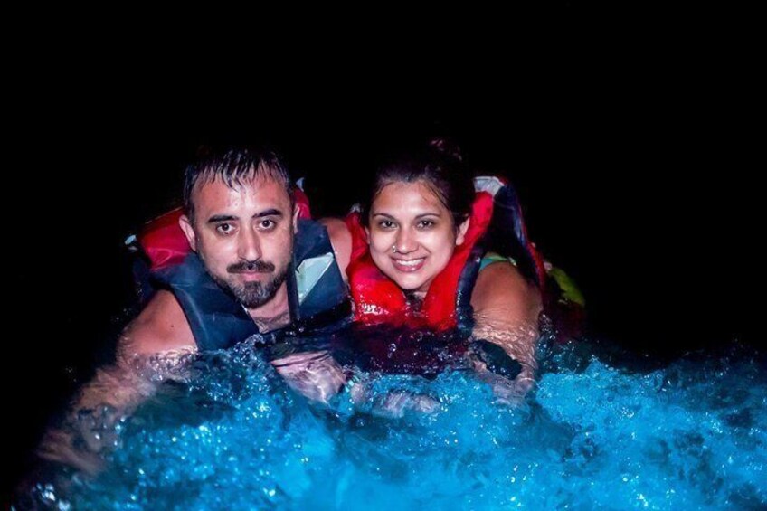 Two people in a hot tub wearing life jackets. 2